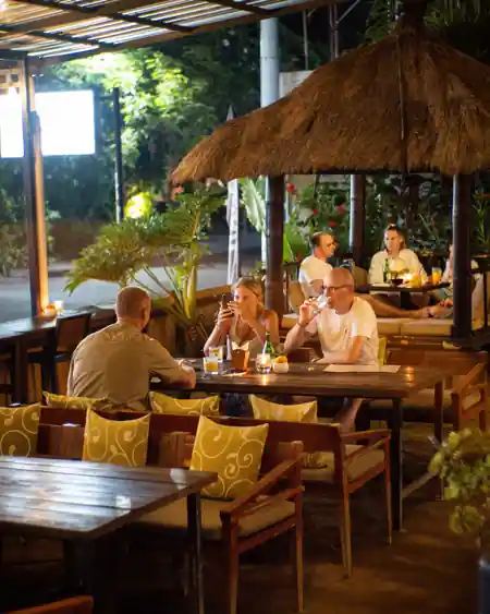 Guests enjoying drinks under thatched gazebo lighting at Beach Garden in Bali — salsa, bachata venue in Bali