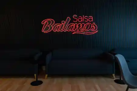 Neon Bailamos Salsa sign with seating area at Bailamos Salsa studio, Basel