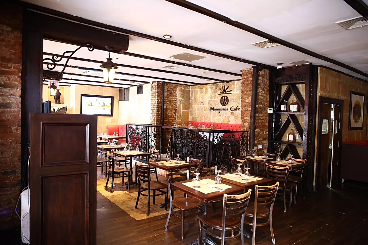 Interior of Mamajuana Cafe in New York with exposed brick and branded signage — salsa venue in New York