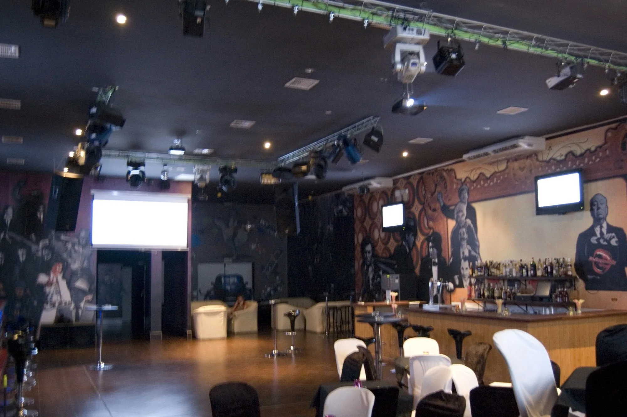 Empty dance floor interior of Sala La Farándula Málaga with bar and murals