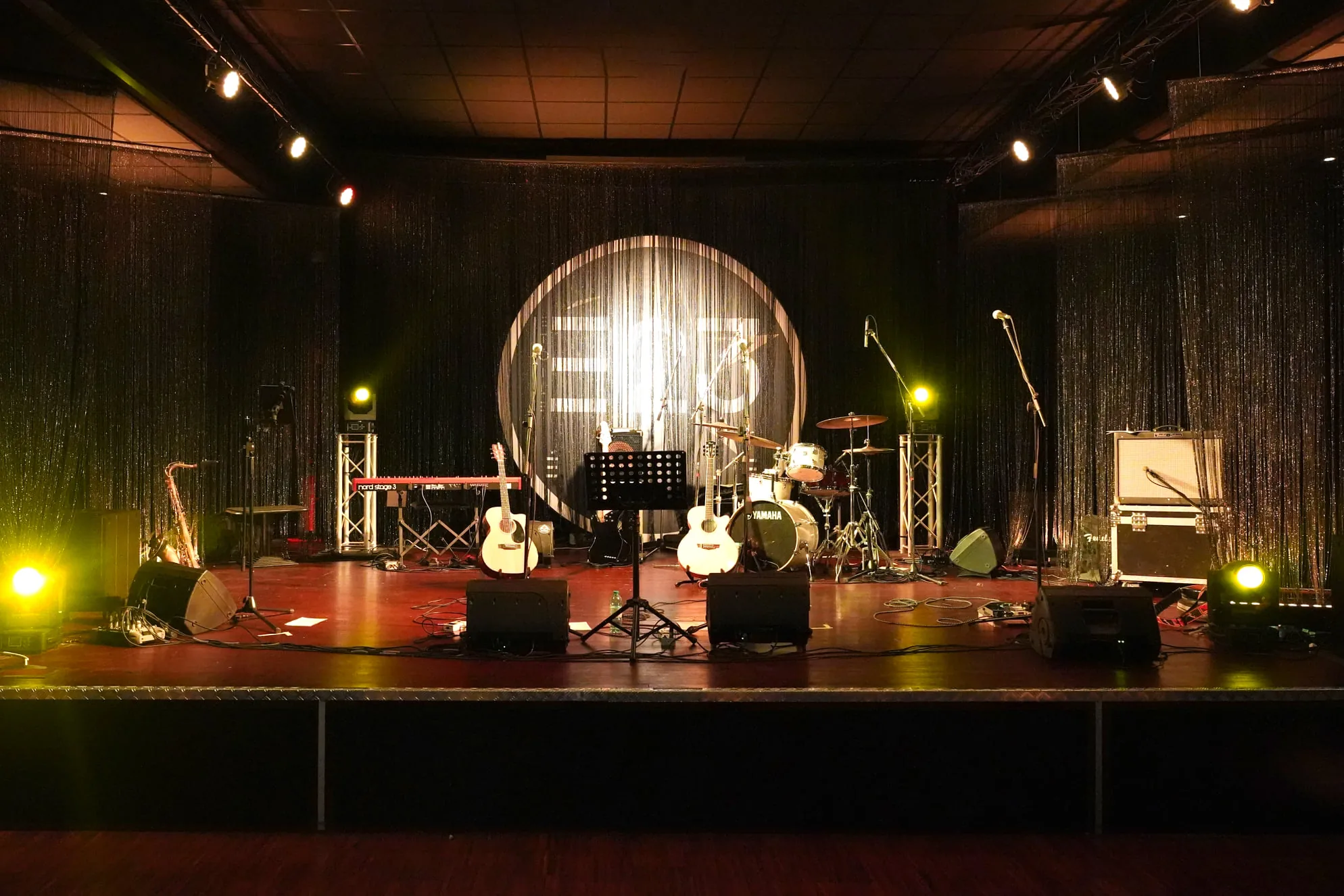 Live band stage setup with instruments at Zanussi music venue in Rome