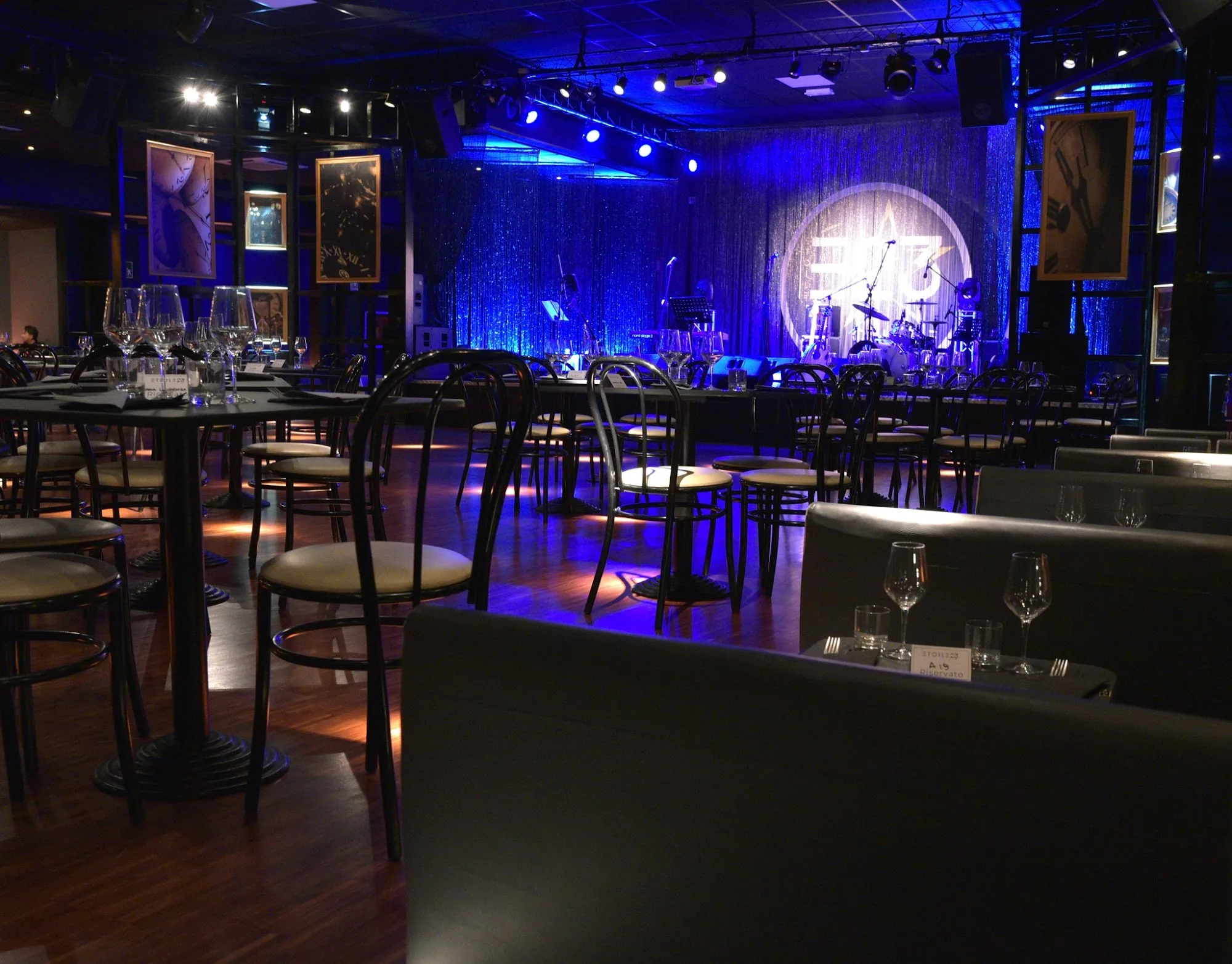 Zanussi Rome bar interior with tables and illuminated stage in the background