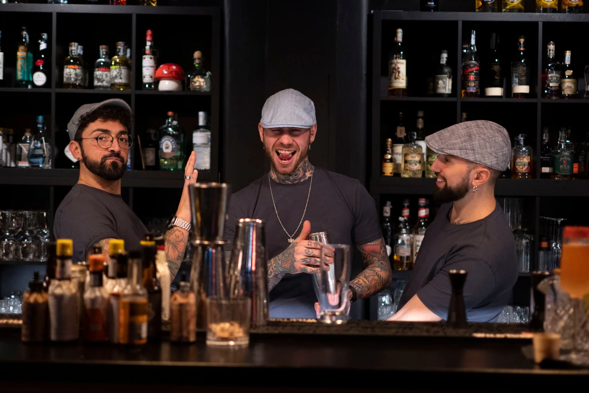 Three bartenders behind the bar at Zanussi nightclub in Rome Italy