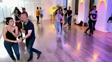 Salsa social dancers in partner hold on the wooden floor at Dolce Vita Dance Studio Berlin