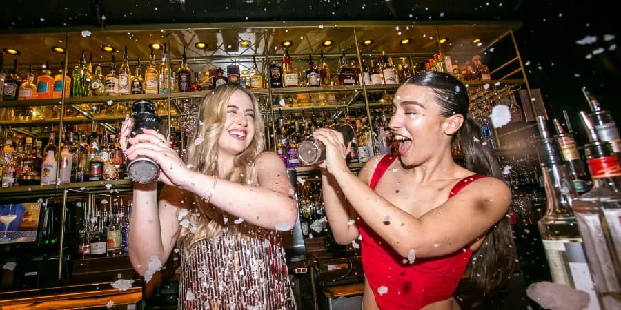 Bartenders shaking cocktails behind the bar at Be At One Liverpool Street London