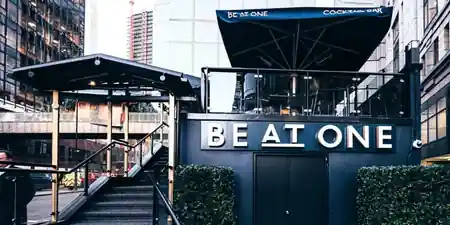 Be At One Liverpool Street exterior with illuminated signage and outdoor terrace near Liverpool Street station — salsa, bachata, kizomba venue in London