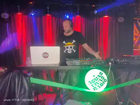 DJ performing on stage with red and blue lighting at Sala Bubaloo, Elche — salsa, bachata, kizomba venue in Elche