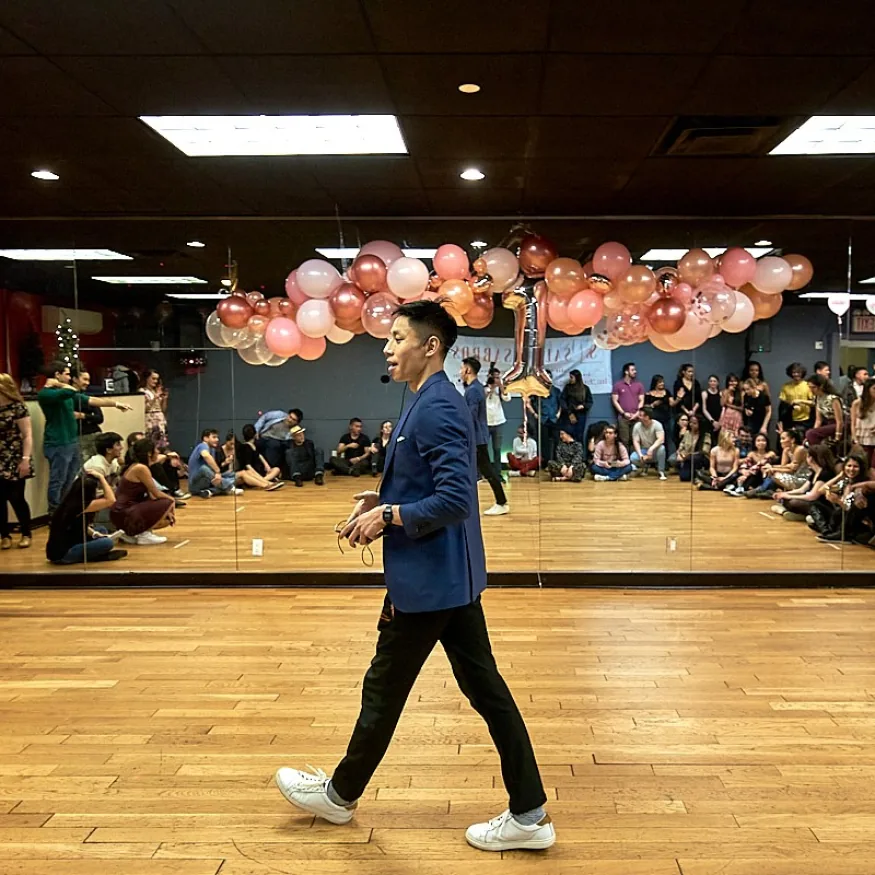 Speaker on the wooden dance floor with seated audience at Little Dreams Event Space in New York
