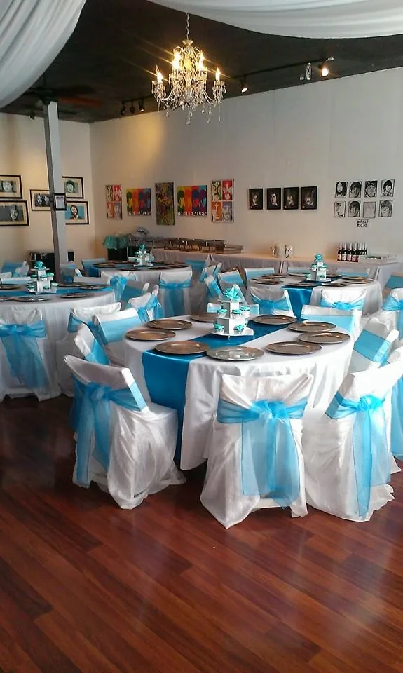 Queen Bee's interior in San Diego with wood floor, chandelier, artwork and event seating