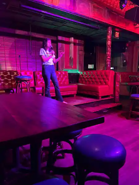 Stage and lounge interior at Tiki Rock club in Boston with red leather seating — salsa venue in Boston