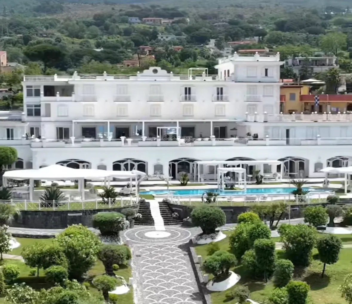 Aerial view of white Zeno Complex venue with pool and gardens in Ercolano Italy