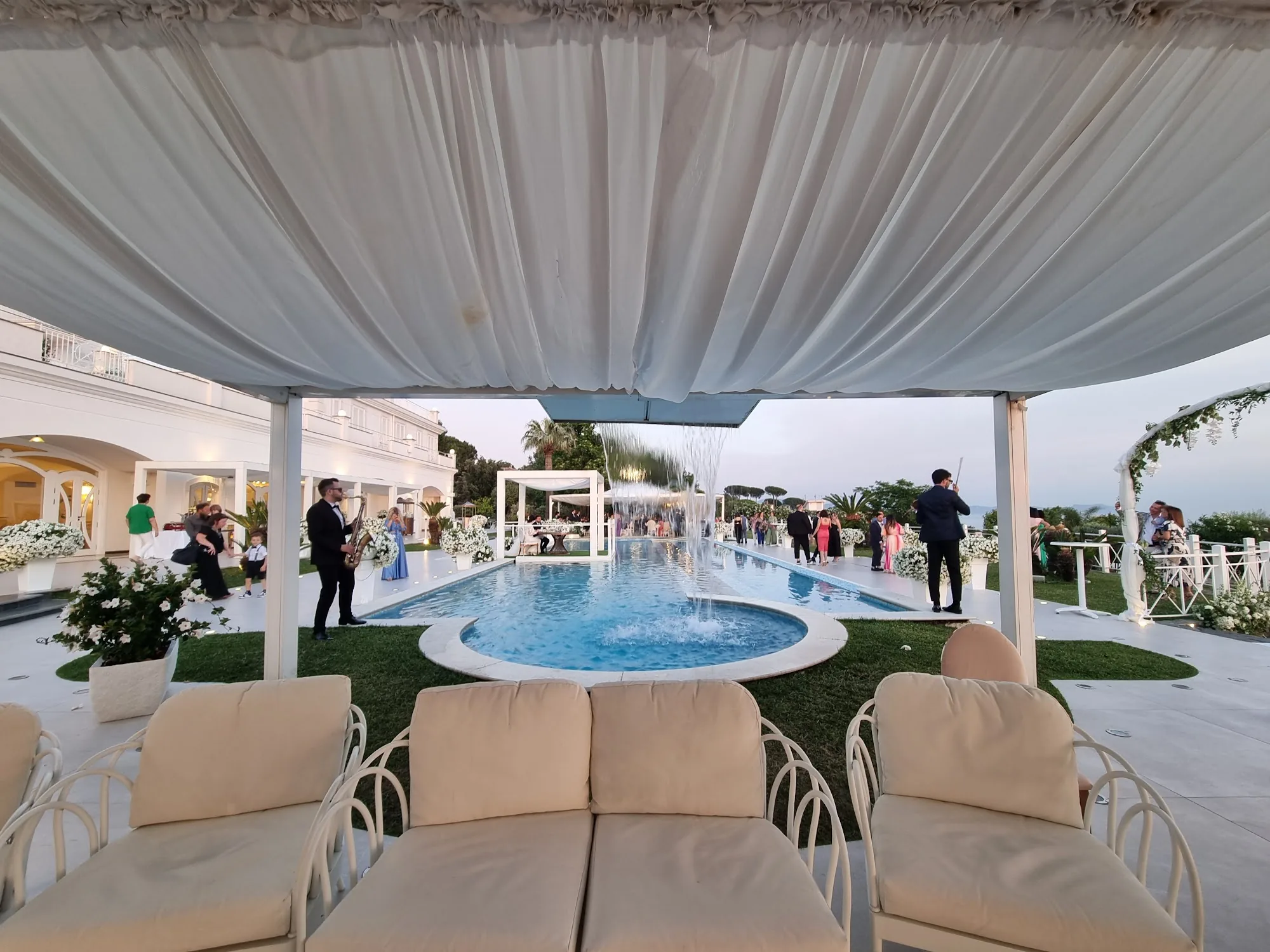 Outdoor poolside event space with guests at Zeno Complex Ercolano Italy