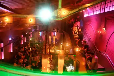 Multi-level dance floor with crowd and colorful club lighting at Soda Social Club Berlin — bachata, kizomba, salsa venue in Berlin