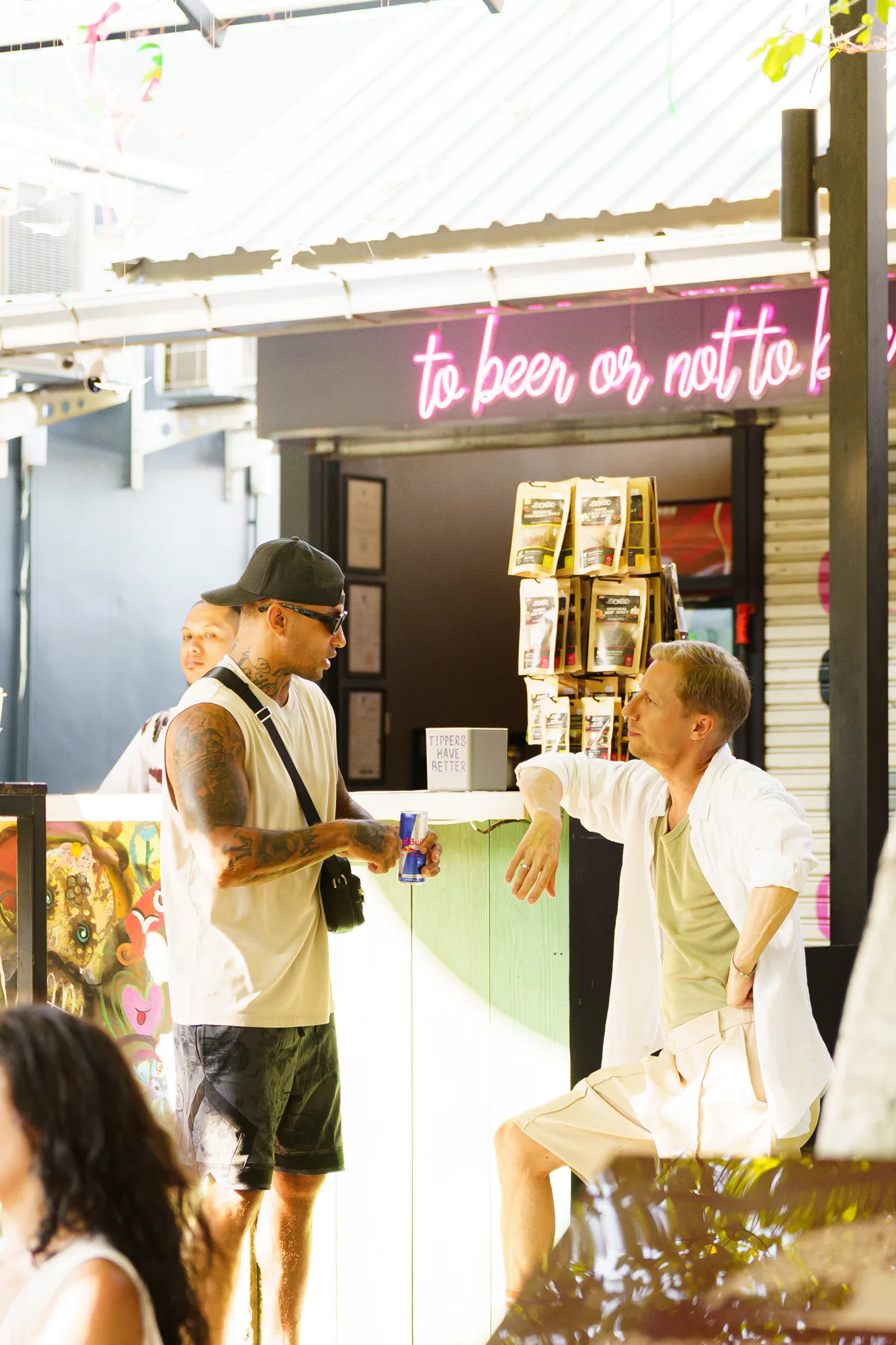 Guests chatting by the neon-lit beer bar at Banyan Food Market in Koh Samui — salsa, bachata, kizomba venue in Koh Samui