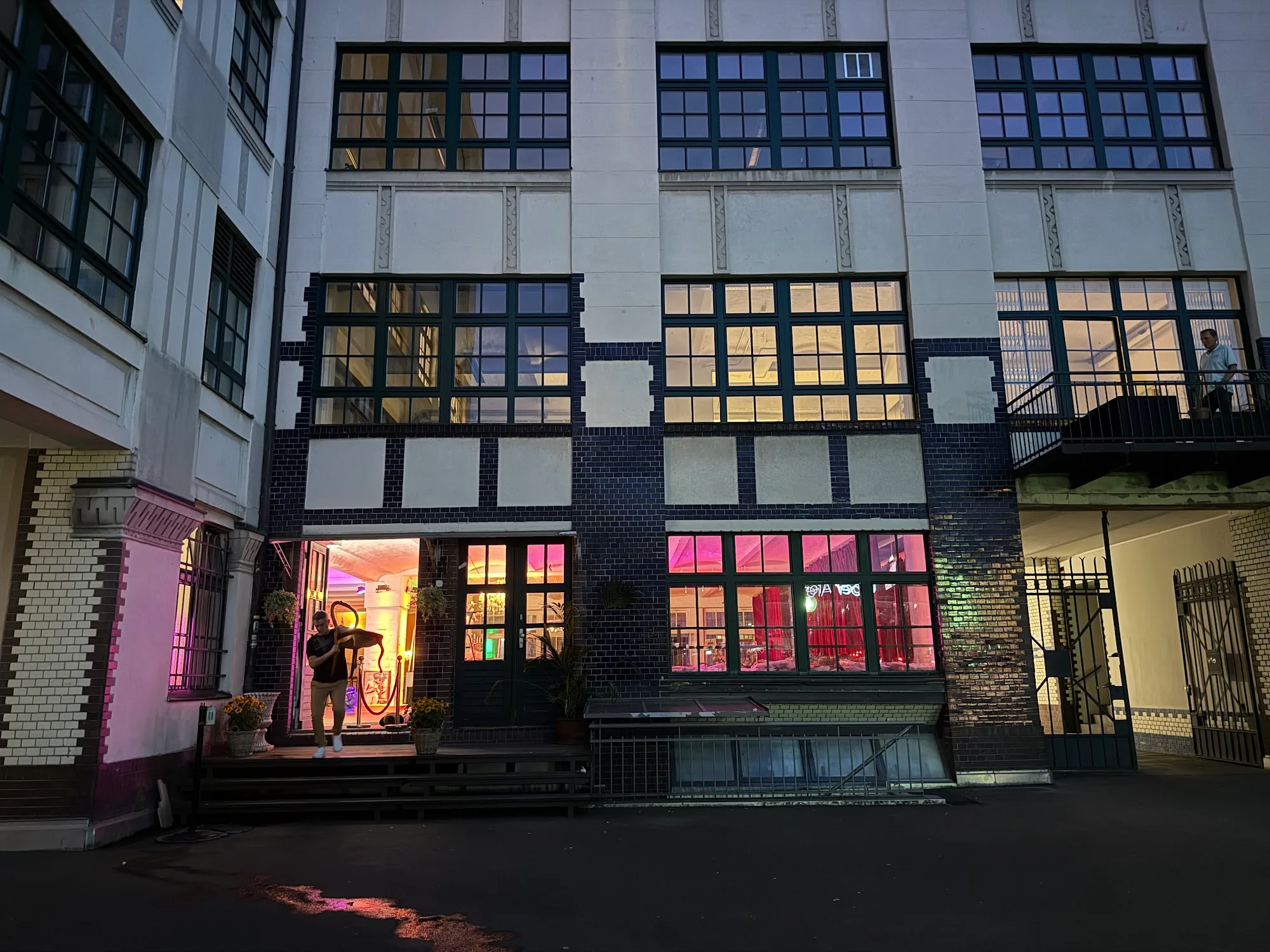 Night exterior of Tangoloft Berlin industrial building lit with purple event lighting