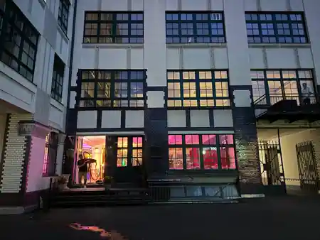 Night exterior of Tangoloft Berlin industrial building lit with purple event lighting — salsa, bachata venue in Berlin