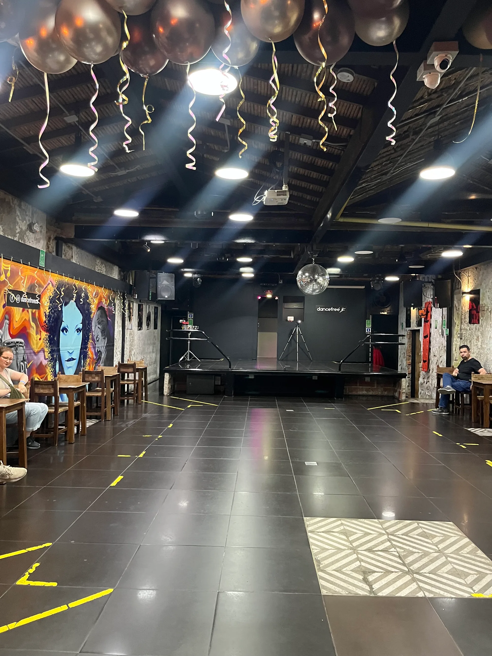 Empty dance floor and stage with disco ball at Dancefree Medellin, salsa, bachata venue in Medellin
