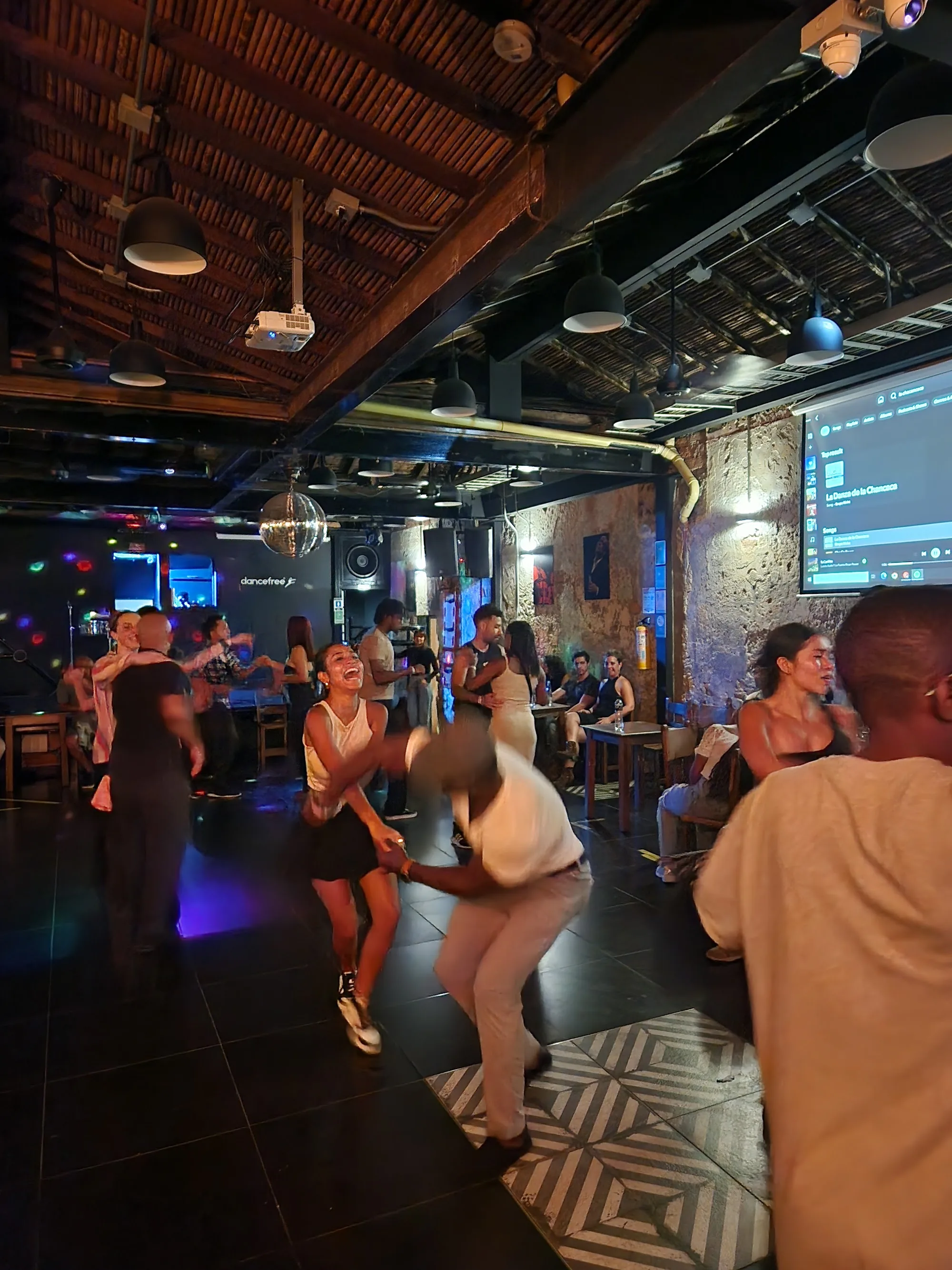 Lively salsa party with dancers and disco ball at Dancefree Medellin