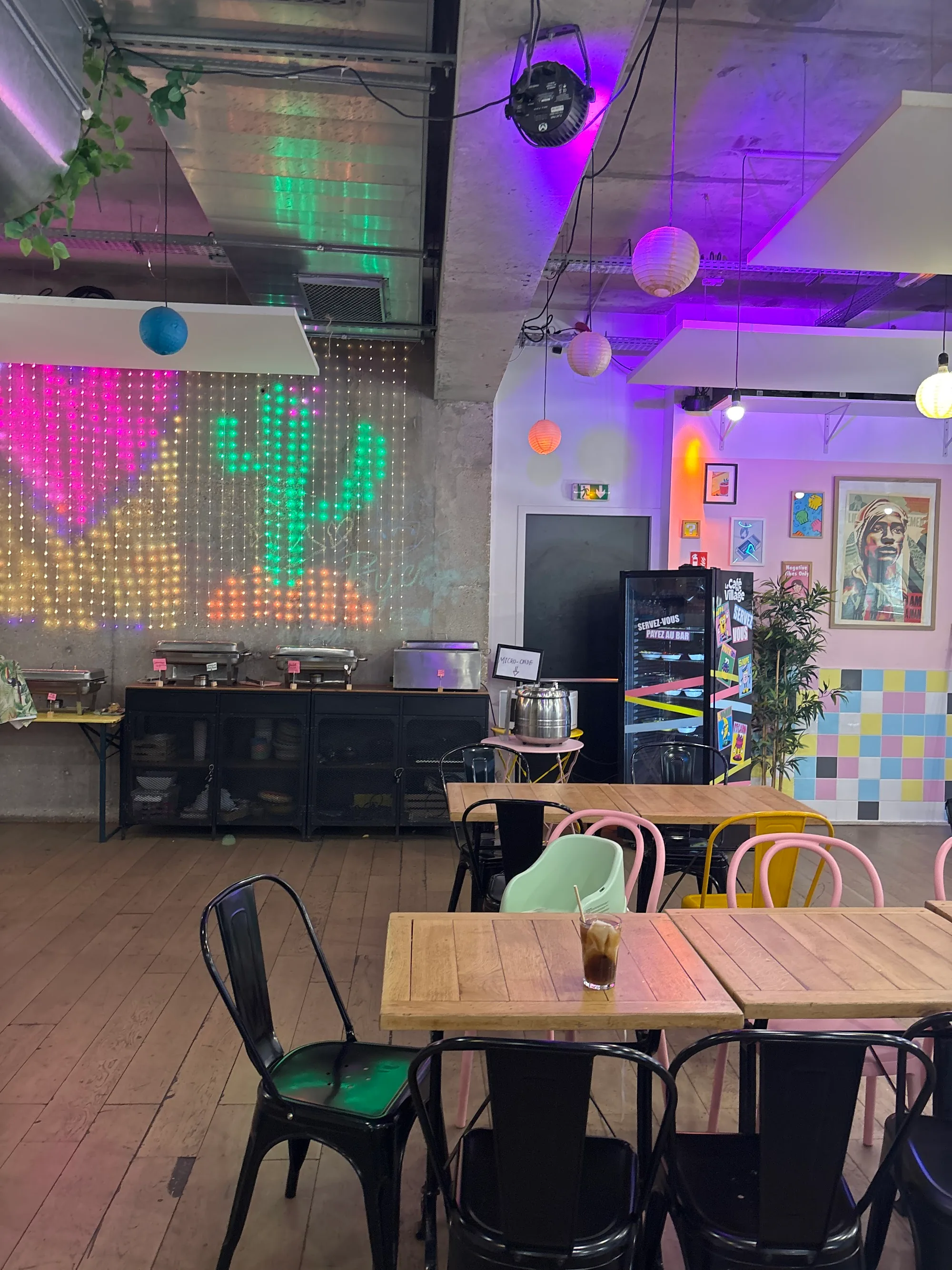 Bar counter with drinks being served under atmospheric club-style lighting