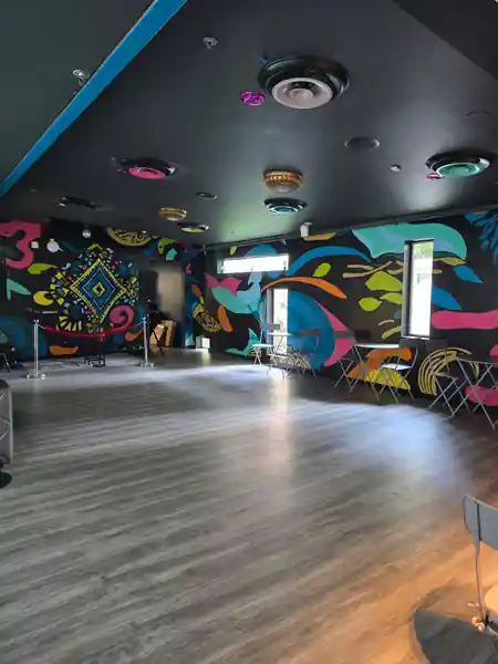 Dance floor with colorful mural walls at Crazy Conchaz Austin Texas — salsa, bachata venue in Austin
