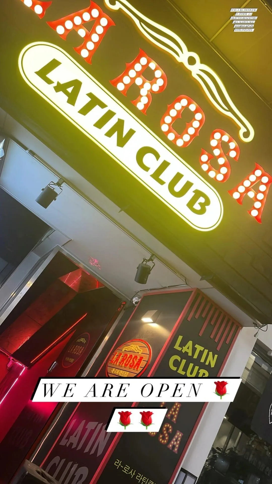 Multiple couples social dancing on a lit dance floor with stage lights at a Latin club in Seoul