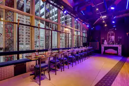 Owen's in Paris — long dining and dance floor space with stained-glass windows and purple stage lighting — salsa, bachata venue in Paris