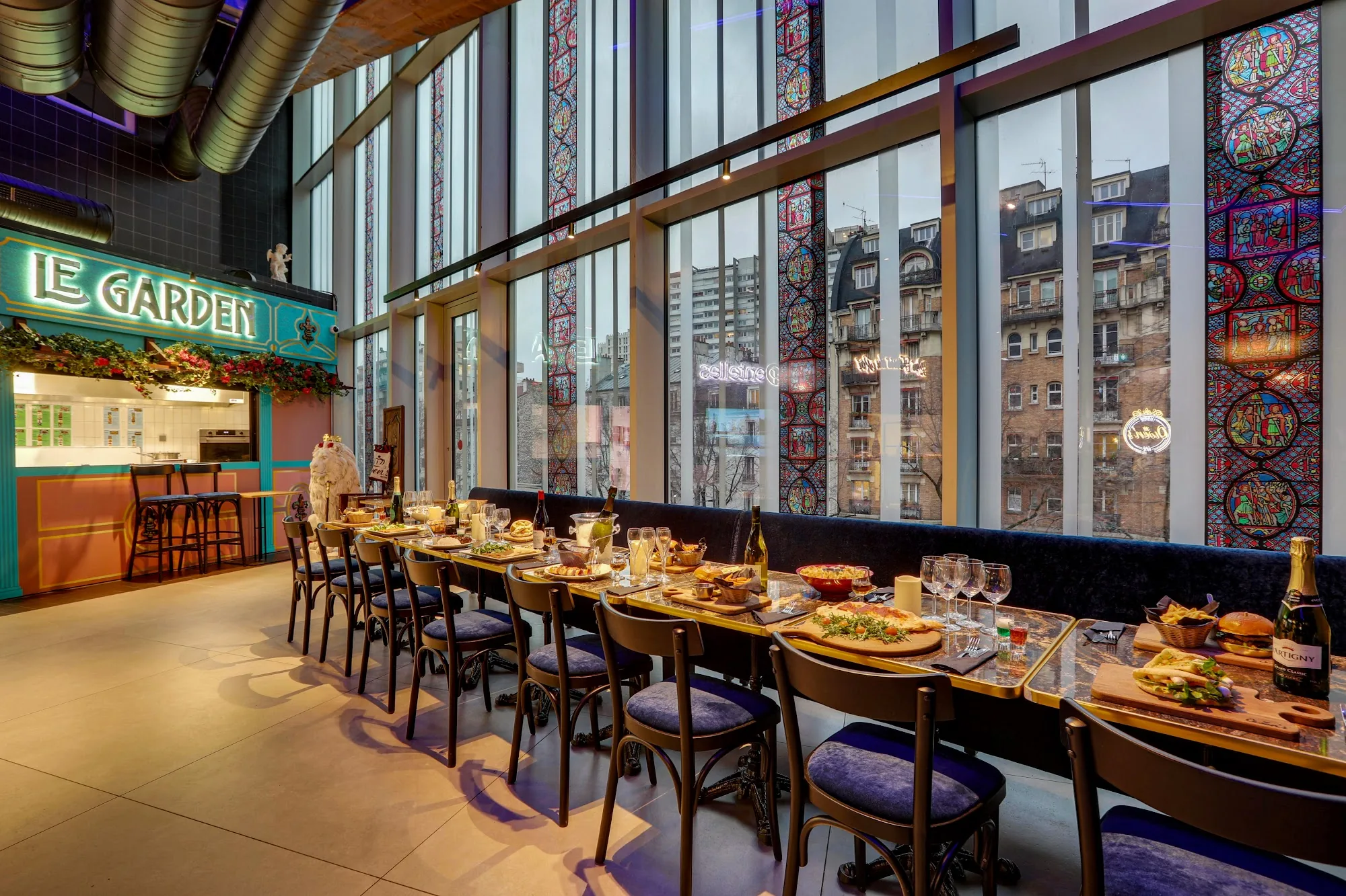 Owen's bar and lounge in Paris — Le Garden dining area with stained-glass windows and Paris rooftop view