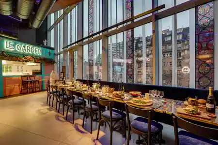 Owen's bar and lounge in Paris — Le Garden dining area with stained-glass windows and Paris rooftop view — salsa, bachata venue in Paris