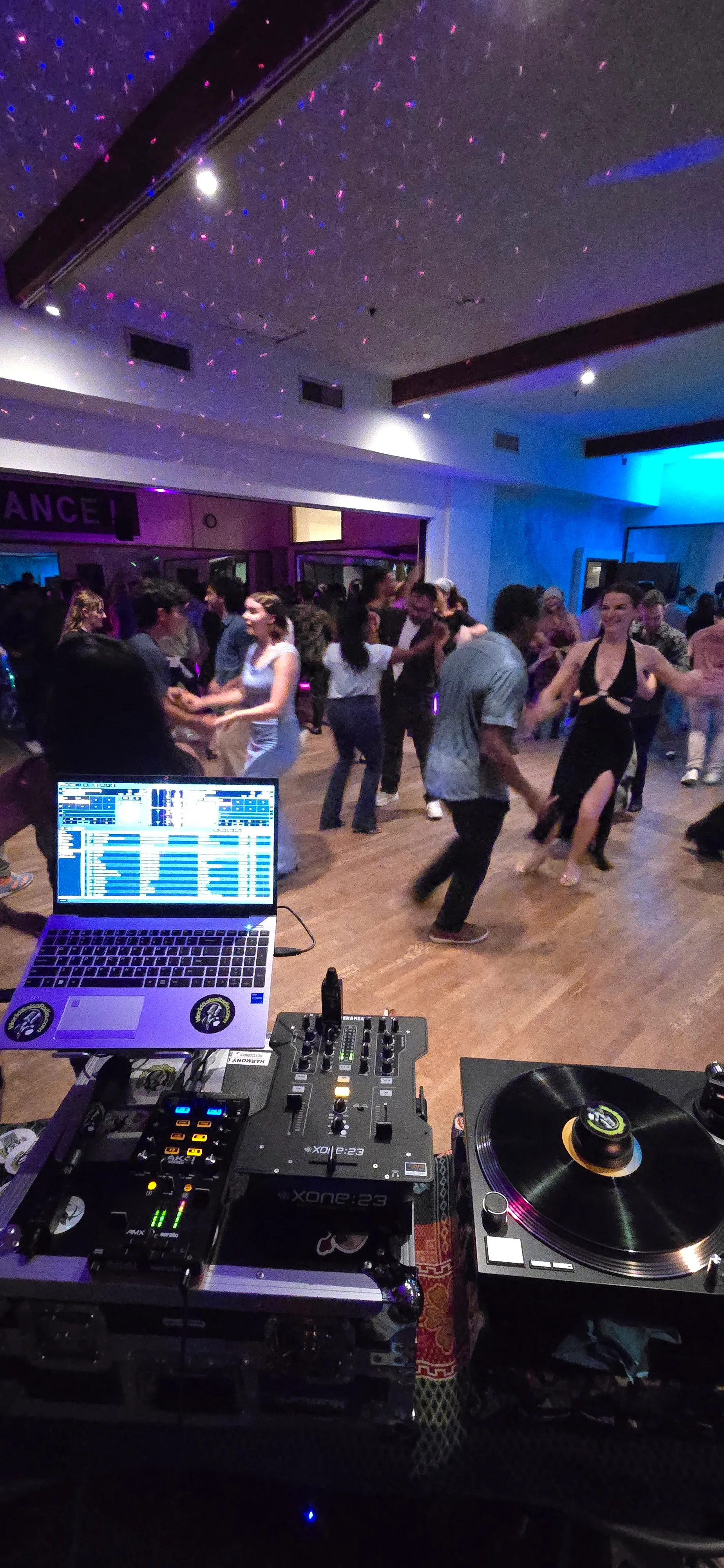 Couples social-dancing under purple and blue club lights at The Beat in Berkeley