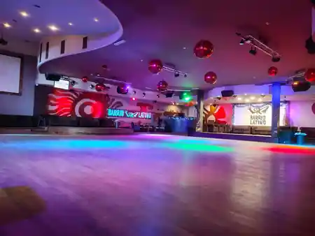 Empty dance floor with disco balls and Barrio Latino branded wall at the Rome club — salsa, bachata, kizomba venue in Lisbon