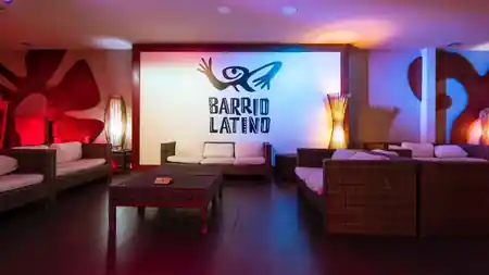 Lounge seating area with the Barrio Latino logo wall and club lighting in Rome — salsa, bachata, kizomba venue in Lisbon