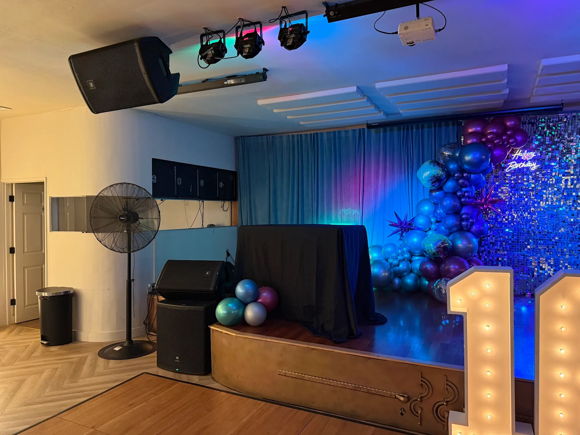 Stage with DJ/PA setup, stage lights and balloon decoration at Little Light Venue Los Angeles