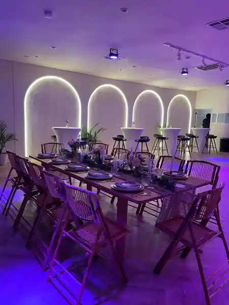 Event hall at Little Light Venue with illuminated arch features, long dinner table and purple lighting — salsa venue in Los Angeles