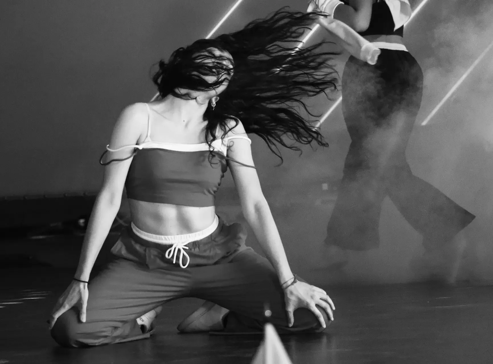 Dancer mid-performance with neon-lit dance floor atmosphere at Studio 17 in Milan