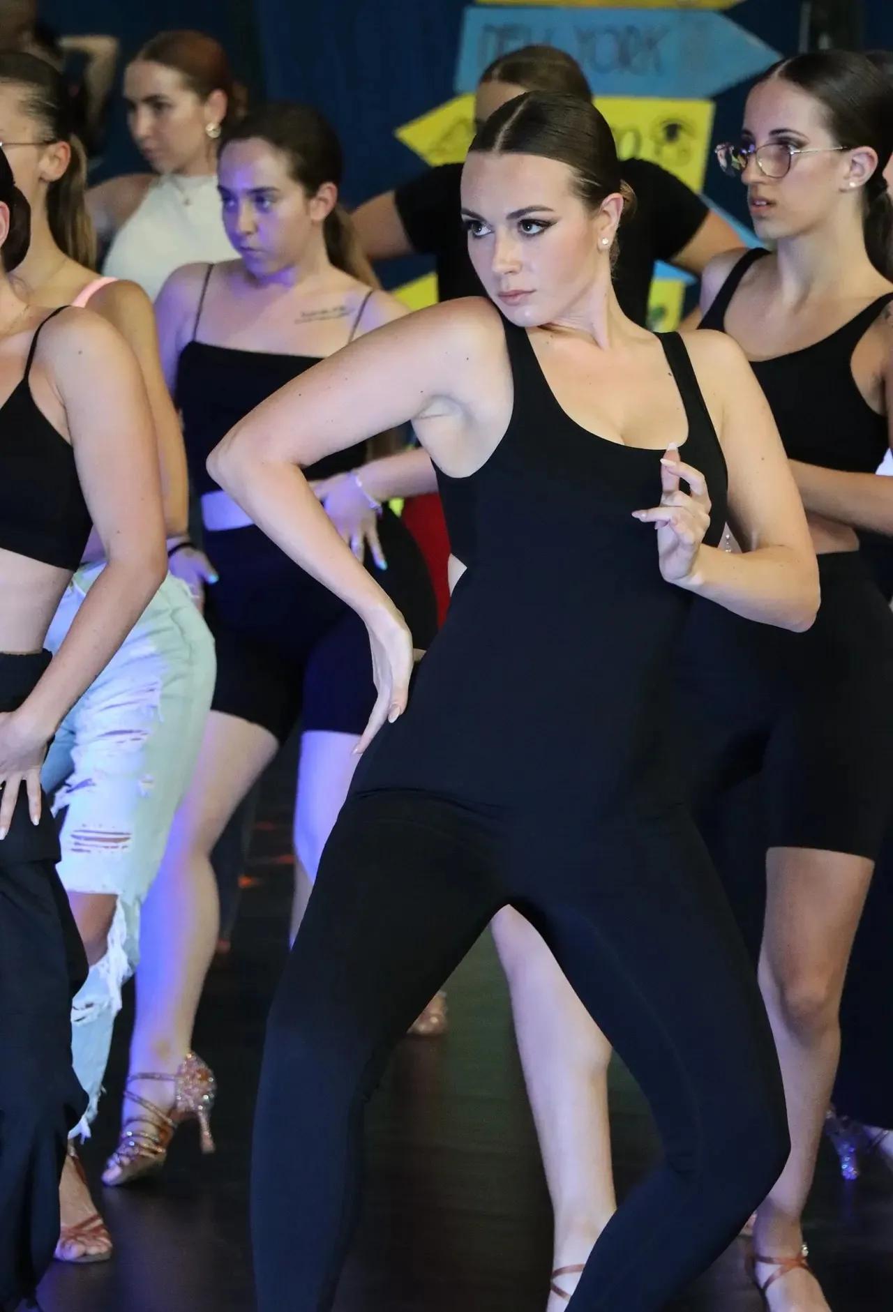 Group of dancers in formation during a Latin dance class at Studio 17 in Milan