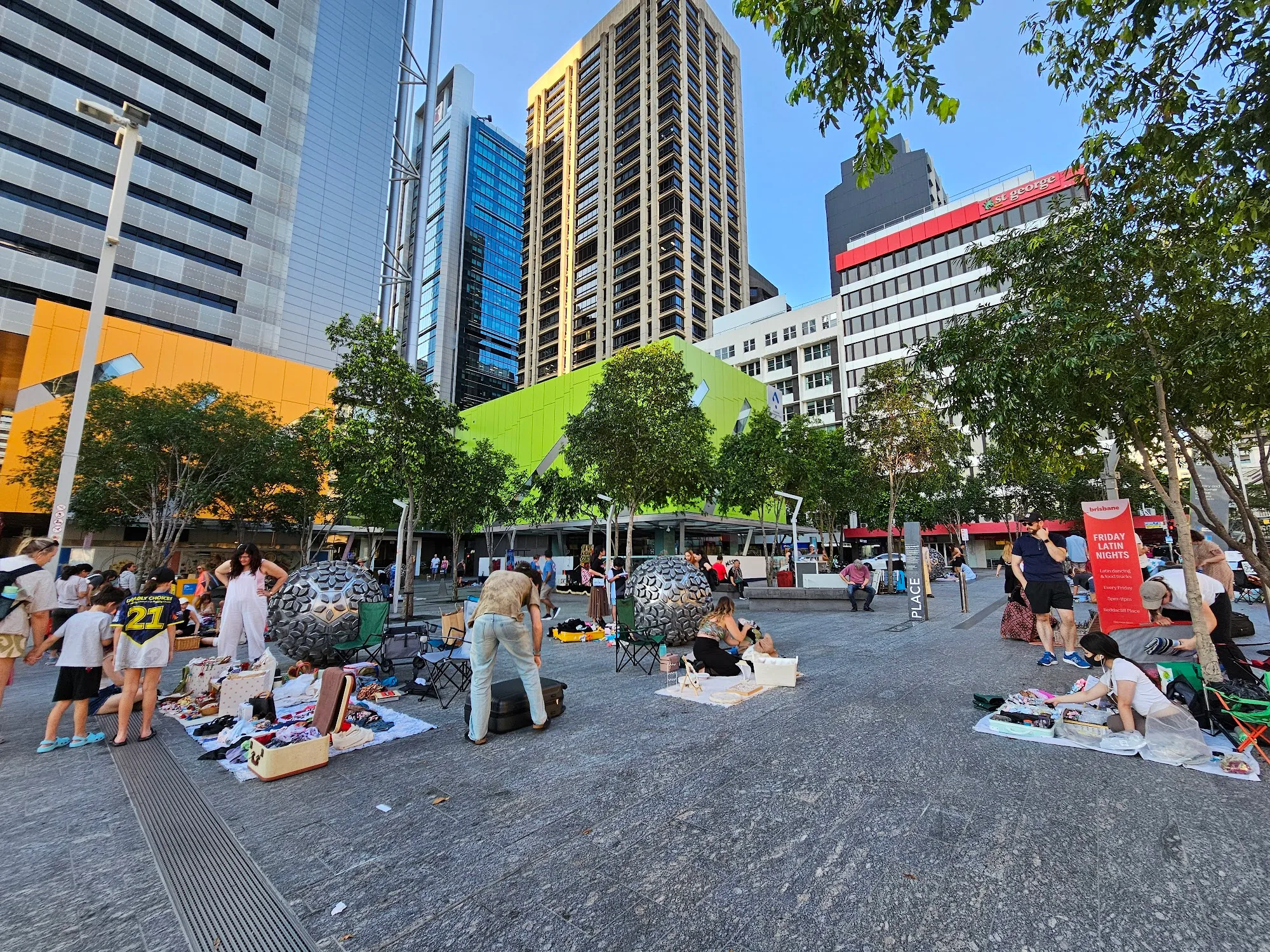 Reddacliff Place Brisbane CBD — outdoor public square with sphere sculptures, trees and market stalls — salsa, bachata, merengue, reggaeton, mix venue in Brisbane
