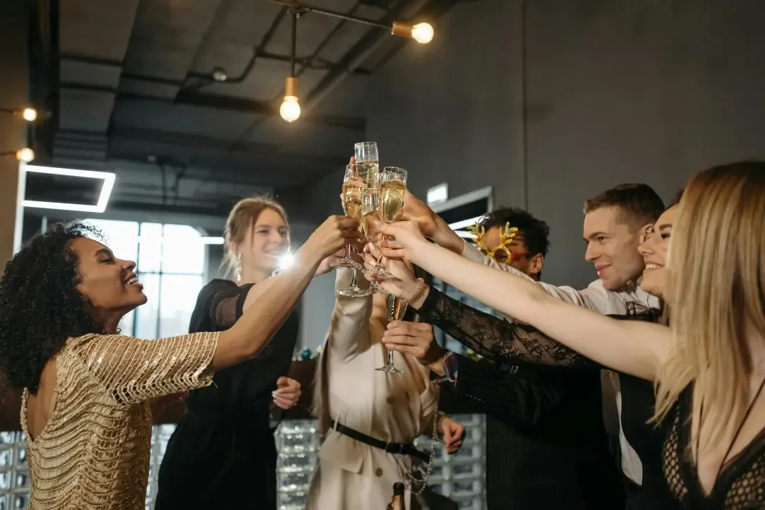Elegantly dressed group toasting champagne at a Mille 18 Events party in Bucharest