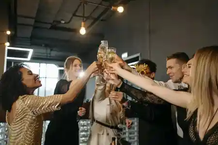 Elegantly dressed group toasting champagne at a Mille 18 Events party in Bucharest — salsa, bachata, kizomba venue in Bucharest