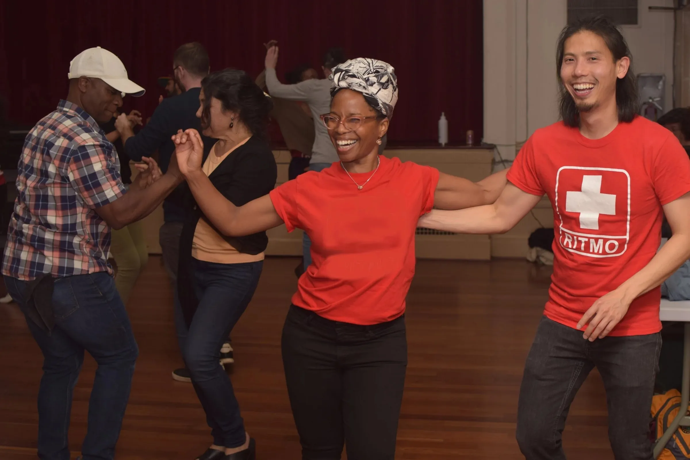 Dancers laughing mid-move at a Rueda con Ritmo social at Mars Bar & Restaurant, San Francisco