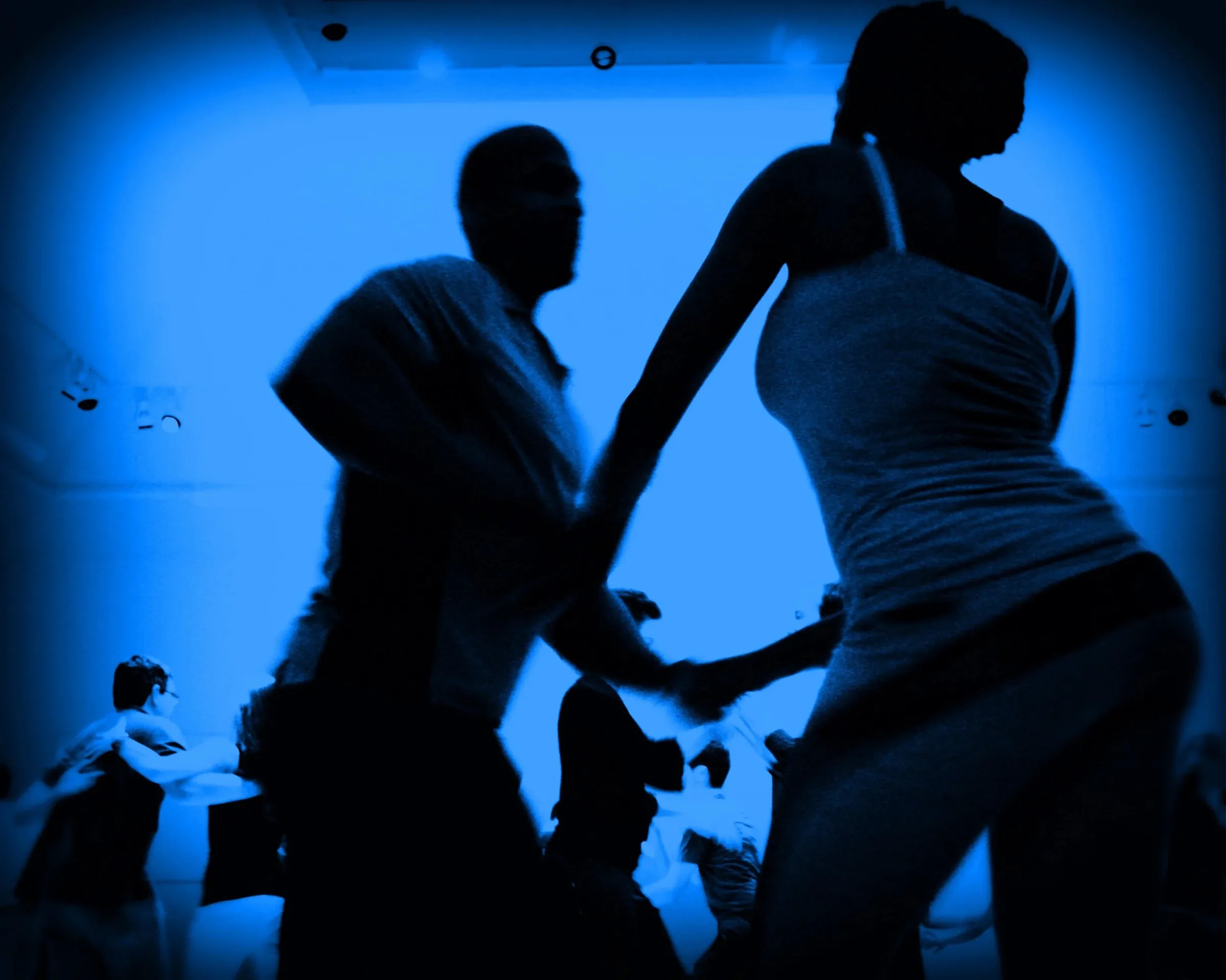 Silhouetted couple social dancing under blue club lighting at Mars Bar & Restaurant, San Francisco