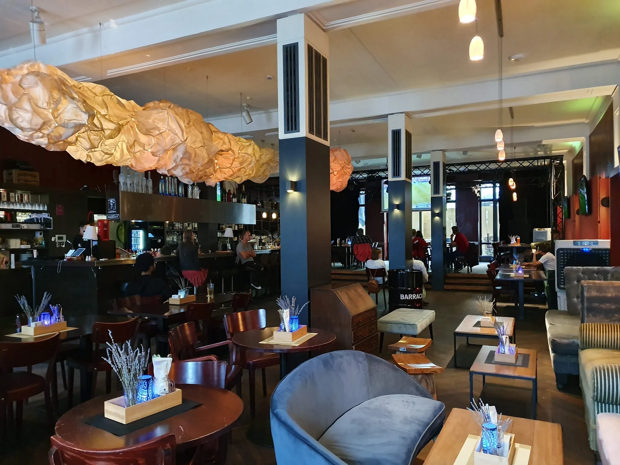 Interior lounge and bar with statement cloud lighting at Das Wohnzimmer in Wiesbaden