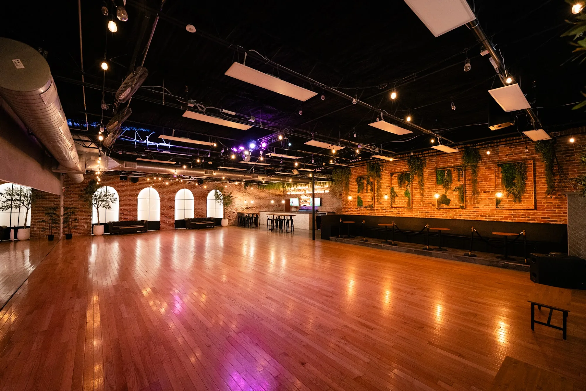 Main ballroom and wooden dance floor with string lights at The Palladium, Houston