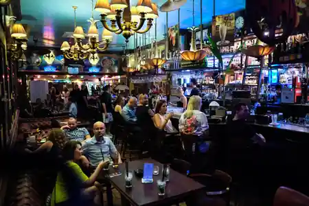 Busy night at Casa de la Musica Wroclaw with guests at the bar and ornate chandeliers — salsa, bachata venue in Wroclaw