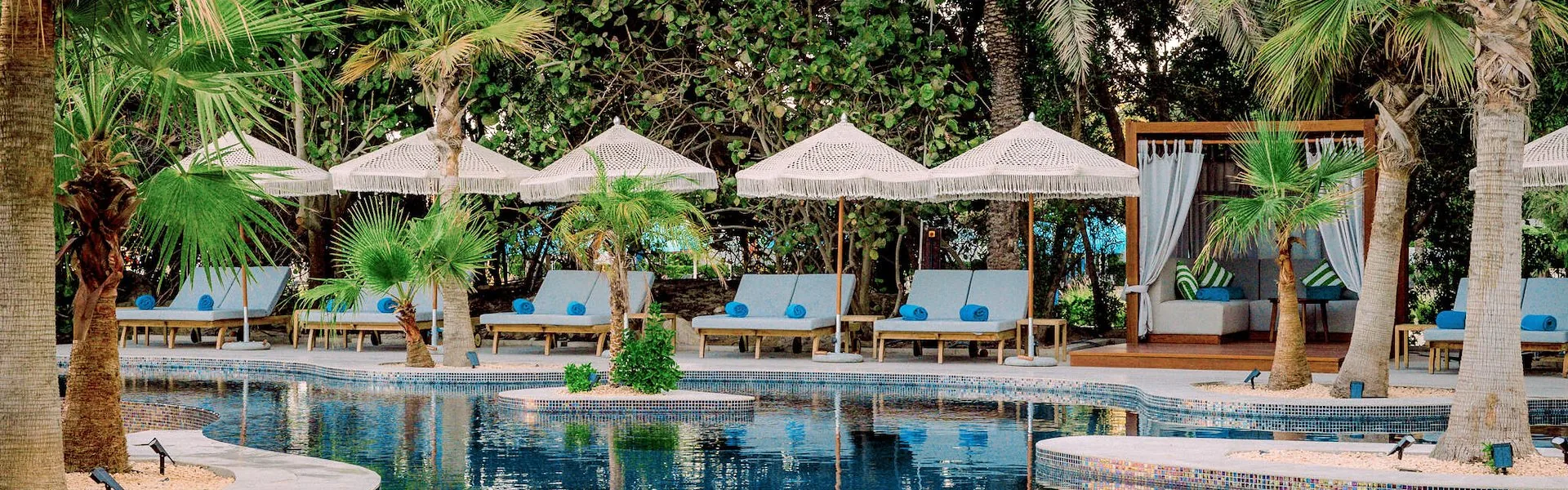 Pool, palm trees and beach cabanas at Barasti Beach in Dubai — salsa, bachata venue in Dubai