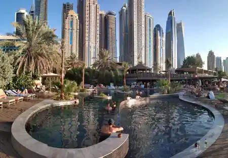 Pool deck with guests and Dubai Marina skyline backdrop at Barasti Beach — salsa, bachata venue in Dubai