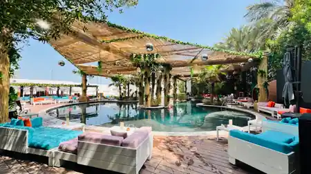 Pool cabanas, daybeds and disco balls at Barasti Beach pool deck in Dubai — salsa, bachata venue in Dubai