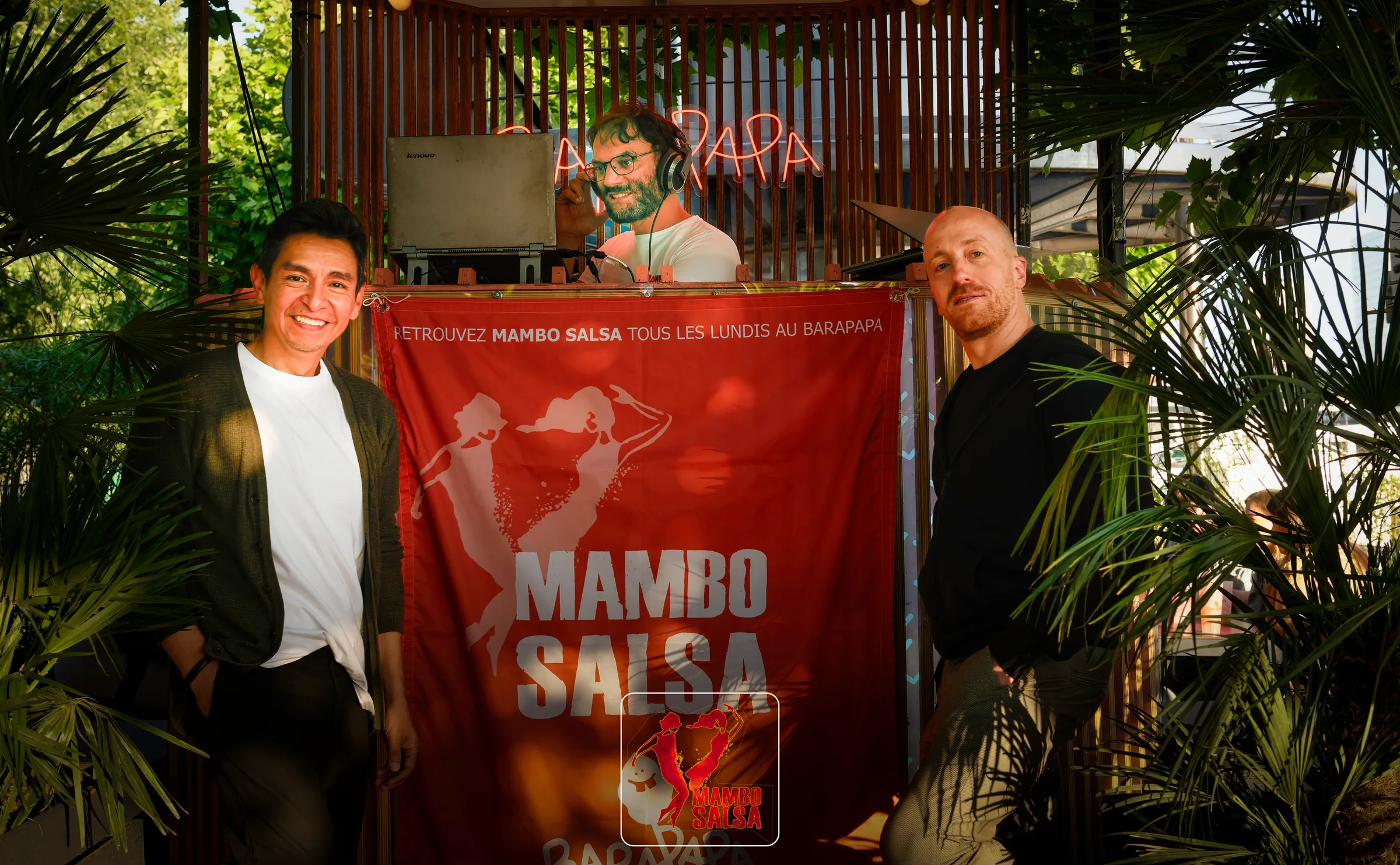 DJ booth with Mambo Salsa banner and guests at The Station, Paris