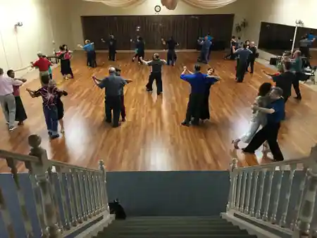 Ballroom social dance with multiple couples on wooden floor at Hollywood Academy of Dance Los Angeles — kizomba venue in Los Angeles