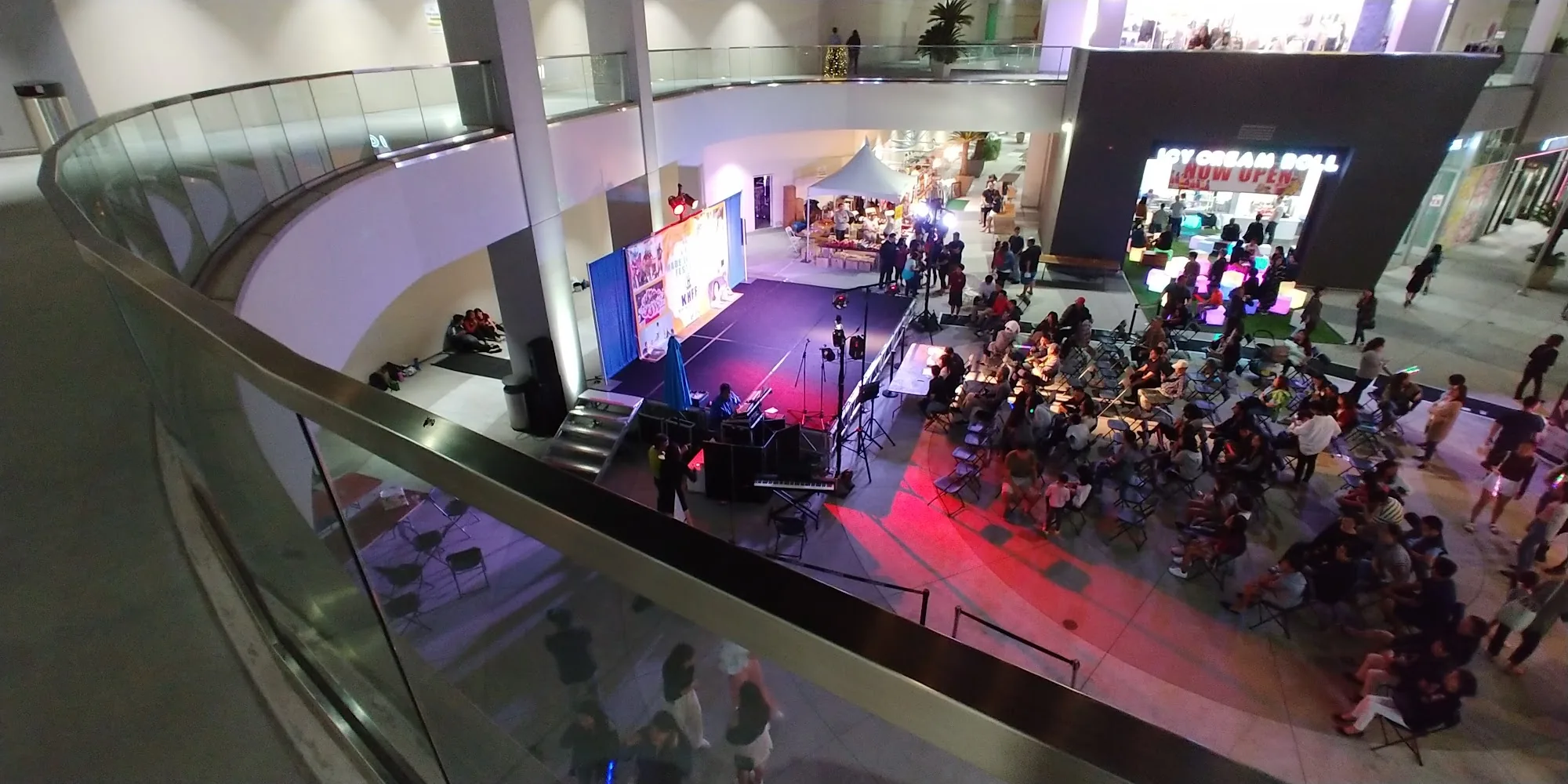 Live performance event in The Source OC mall atrium with stage and crowd in Buena Park