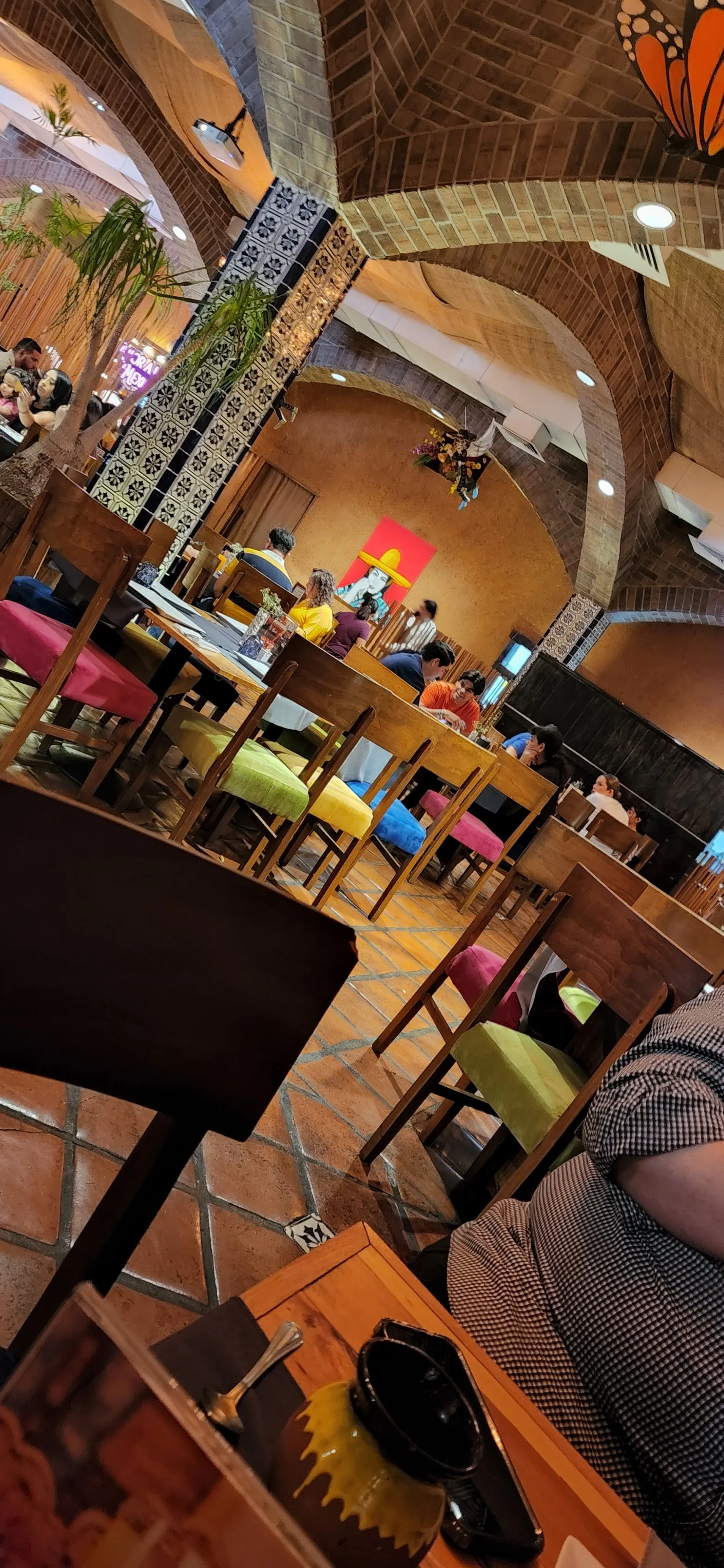Beer Garden Plaza Juárez colorful interior with brick arches and diners